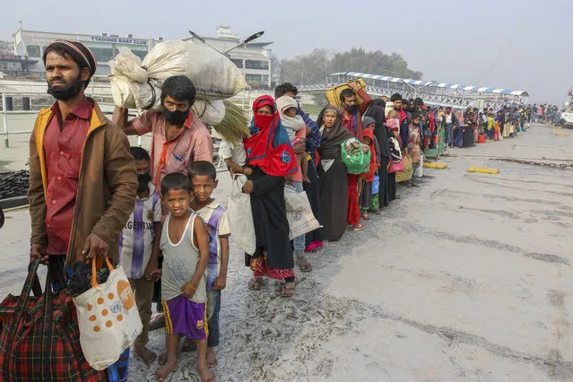 In this February 15, 2021, file photo, Rohingya refugees headed to the Bhasan Char island prepare to board navy vessels from the south eastern port city of Chattogram, Bangladesh. The United Nations said Wednesday, Feb. 24, 2021, that a group of Rohingya refugees is adrift in a boat in the Andaman Sea without food or water, and that their families are worried that many may have already died. (Photo by AP Photo/Stringer)