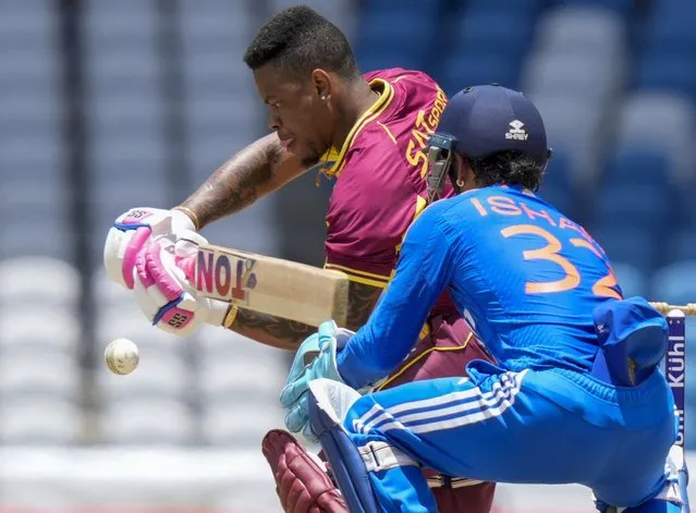 West Indies' Shimron Hetmyer plays a shot under the watch of India's keeper Ishan Kishan during their first T20 cricket match at the Brian Lara Stadium in Tarouba, Trinidad and Tobago, Thursday, August 3, 2023. (Photo by Ramon Espinosa/AP Photo)