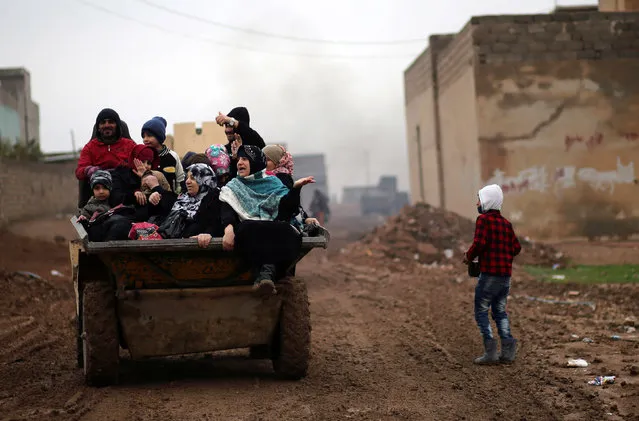 Iraqi people ride in a truck as they flee the Islamic State stronghold of Mosul in al-Samah neighborhood, Iraq December 1, 2016. (Photo by Mohammed Salem/Reuters)