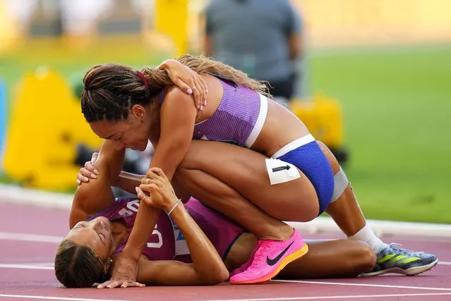 Gold medal winner Katarina Johnson-Thompson, of Great Britain, top, greets silver medalist Anna Hall, of the United States after finishing the heptathlon 800-meters during the World Athletics Championships in Budapest, Hungary, Sunday, August 20, 2023. (Photo by Petr David Josek/AP Photo)