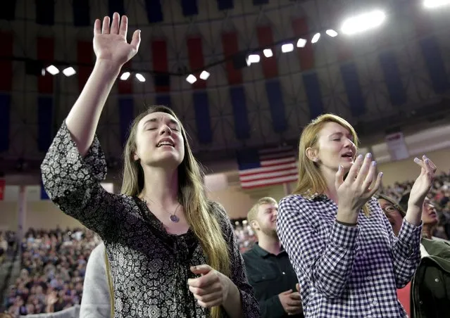 Lesley Chambers (L) of Champaign, Illinois and Brensley Baker of San Francisco, California, hold their hands up as they sing before U.S. Republican presidential candidate Donald Trump arrival at Liberty University in Lynchburg, Virginia,  January 18, 2016. (Photo by Joshua Roberts/Reuters)