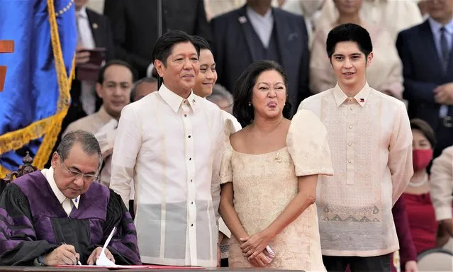 President Ferdinand Marcos Jr., second from left, and wife Maria Louise reacts after being sworn in by Supreme Court Chief Justice Alexander Gesmundo, left, during the inauguration ceremony Thursday, June 30, 2022, in Manila, Philippines. Marcos was sworn in as the country's 17th president. (Photo by Aaron Favila/AP Photo)