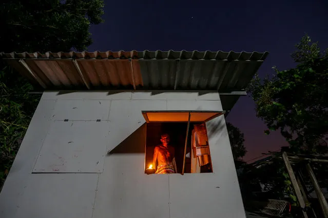 Choochart Supkerd, 63, who studies at the School for the Elderly in Chiang Rak Noi subdistrict, poses for a photograph inside his house in Ayutthaya, Thailand, March 28, 2018. Supkerd attended a 12-week course at the school which he said was a welcome relief from his “stressful” life. “It's stressful just living day by day. I don't have an income”, he said. “I receive disabled welfare of 800 baht ($25.60/month)”. The school was a place for him to make friends. “I will probably go back to feeling lonely sometimes but I'm also proud of this, of gaining some knowledge in class that would be useful for my daily life”. (Photo by Athit Perawongmetha/Reuters)