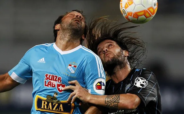 Sergio Blanco of Peru's Sporting Cristal (L) fights for the ball with Ezequiel Videla of Argentina's Racing Club during their Copa Libertadores match  in Lima, March 17, 2015. (Photo by Mariana Bazo/Reuters)