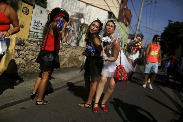 Revellers take part in an annual block party known as “Ceu na Terra” (Heaven on Earth), one of the many carnival parties to take place in the neighbourhoods of Rio de Janeiro, January 30, 2016. (Photo by Pilar Olivares/Reuters)