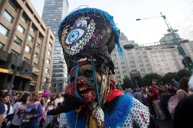 A person dressed as a zombie reacts during the annual Zombie Walk in Mexico City, Mexico on October 21, 2023. (Photo by Quetzalli Nicte-Ha/Reuters)