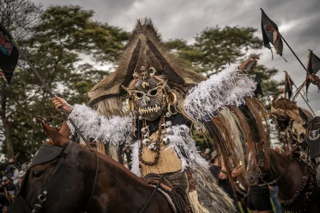 A “Cachacero” (Cuadrillero) parades in his horse during the “Cuadrillas de San Martin” as part of the 56th Folkloric and Tourist International Festival of the “llano” on November 12, 2023 in San Martin, Colombia. The “Cuadrillas de San Martin” is a tradition almost 300 years old in which horsemen in San Martin show their skills in a contest with a series of 10 different games. It is not clear if the tradition comes from Spanish riders or from the Achagua indigenous, but the reason of the games was for fighting the territory between the Galanes, Moros, Guahibos and Cachaceros cultures, representing (in the same order) the Spanish, Arabs, indigenous and Africans. Today, it is one of Colombia's most recognized cultural expressions in the country and abroad. (Photo by Diego Cuevas/Getty Images)