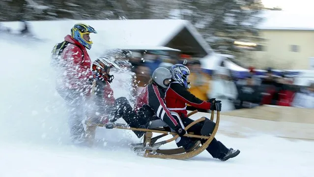 Competitors ride their wooden sledge during a traditional Bavarian horn sledge race “Hornschlittenrennen” in Garmisch-Partenkirchen January 6, 2017. (Photo by Michaela Rehle/Reuters)