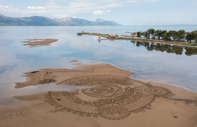 Artist Nikola Faler is seen working on sand drawing in the mouth of the river Neretva during the 7th Zen Opuzen art festival in Opuzen, Croatia, July 5, 2021. (Photo by Antonio Bronic/Reuters)