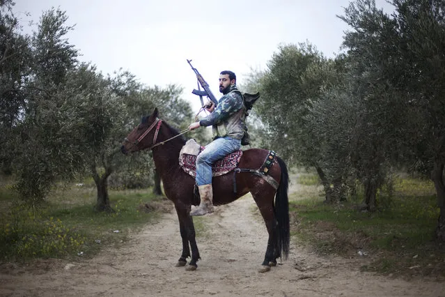 A portrait of a “Free Syrian Army” rebel mounted of his steed in Al-Shatouria village near to the Turkish border in northwestern Syria, on March 16, 2012. (Photo by Giogos Moutafis/AFP Photo)