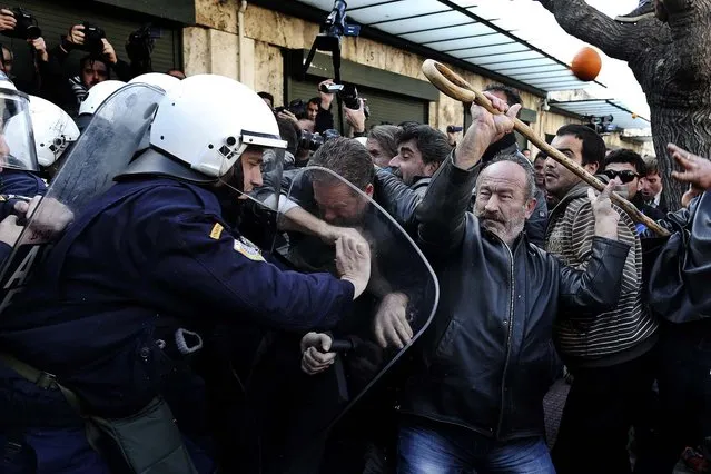 Farmers argue with policemen during a rally against the government's new property tax outside the parliament in Athens, on December 20, 2013. (Photo by John Kolesidis/Reuters)