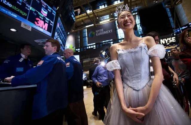 A ballerina from the New York City Ballet's production of  “The Nutcracker” smiles as she tours the floor of the New York Stock Exchange on Christmas Eve in New York, December 24, 2013. (Photo by Carlo Allegri/Reuters)
