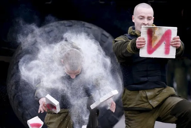 Servicemen of the Belarussian Interior Ministry's special forces unit take part in a presentation during Maslenitsa celebrations at their base in Minsk, Belarus February 28, 2016. Maslenitsa is a pagan holiday marking the end of winter celebrated with pancake eating and shows of strength. (Photo by Vasily Fedosenko/Reuters)