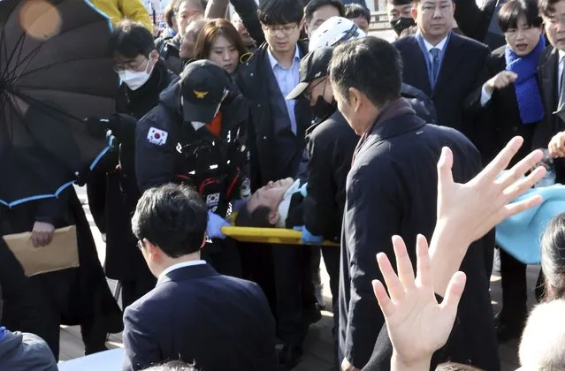 South Korean opposition leader Lee Jae-myung on a stretcher, is carried by rescue team in Busan, South Korea, Tuesday, January 2, 2024. Lee was attacked and injured by an unidentified man during a visit Tuesday to the southeastern city of Busan, emergency officials said. (Photo by Ha Kyung-min/Newsis via AP Photo)