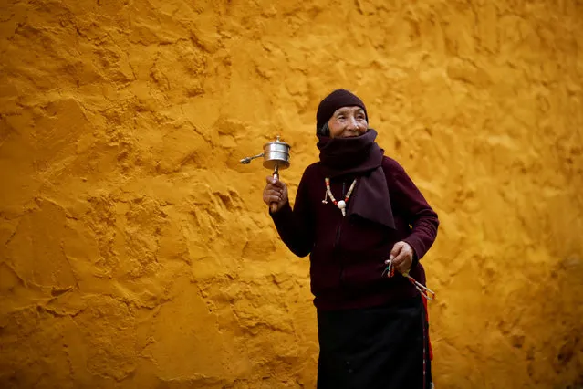 An ethnic Tibetan woman prays at the Langmu Lamasery ahead of “Sunbathing Buddha Festival”, in Gannan Tibetan Autonomous Prefecture, Gansu Province, China, February 16, 2019. (Photo by Aly Song/Reuters)