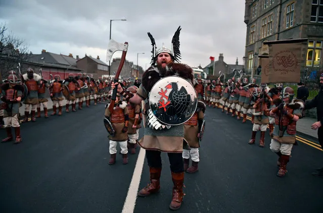 The Guizer Jarl, Lyle Gairmand his Jarl Squad march through the streets of Lerwick on January 31, 2017, in the Shetland Islands, Scotland. The traditional festival of fire is known as “Up Helly Aa”. The spectacular event takes place annually on the last Tuesday of January. The climax of the day comes with participants in full costume hauling a Viking longboat through the streets of Lerwick to the edge of town where up to 1000 people parade and throw their flaming torches into the galley. (Photo by Jeff J. Mitchell/Getty Images)