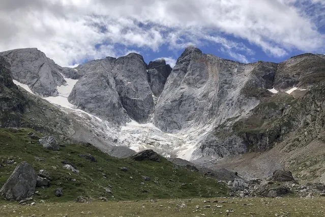 A view of the Petit Vignemale glacier, left, and the Oulettes, right, on the Vignemale massif's north face in the Pyrenean mountain range, as seen from the Gaube valley in southern France, Sunday, August 3, 2020. Spanish scientists say Europe's southernmost glaciers will likely be reduced to ice patches in the next two decades due to climate change. The study also found that the shrinking of ice mass on the Pyrenees mountain range is continuing at the steady but rapid speed seen at least since the 1980s. (Photo by Aritz Parra/AP Photo)