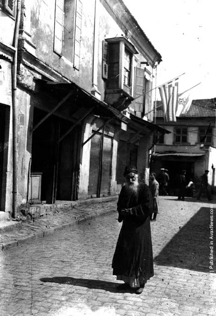 circa 1917:  A bearded Jewish man stands in a cobbled street in Palestine