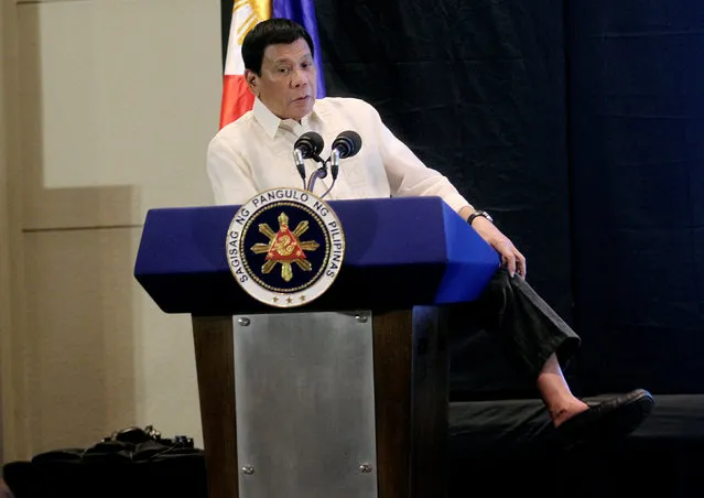 Philippine President Rodrigo Duterte shows he is not wearing socks while speaking at an economic forum in Davao city, in southern Philippines February 10, 2017. (Photo by Lean Daval Jr./Reuters)
