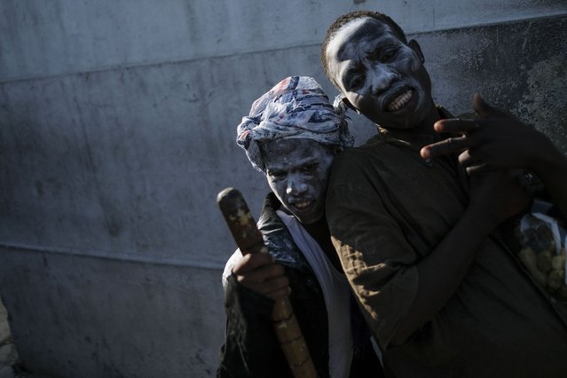 People believed to be possessed with the Gede spirit hold a ceremony honoring the Haitian Vodou spirit of Baron Samedi and Gede at the National Cemetery in Port-au-Prince, Haiti, Monday, November 1, 2021. (Photo by Matias Delacroix/AP Photo)