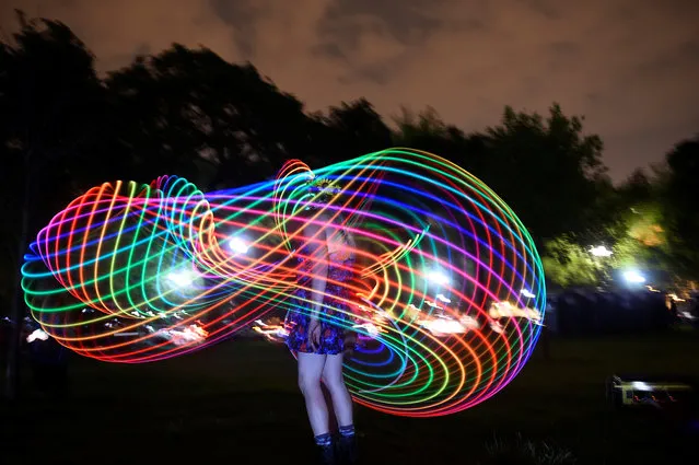 A woman dances with light at an event event called “Catharsis on the Mall” in Washington, U.S., May 4, 2019. (Photo by Clodagh Kilcoyne/Reuters)