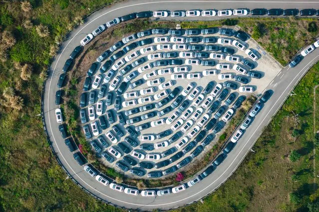 New electric cars for sale are seen parked at a distribution center of the Changan automobile company in southwestern China's Chongqing municipality on March 24, 2024. (Photo by AFP Photo/China Stringer Network)