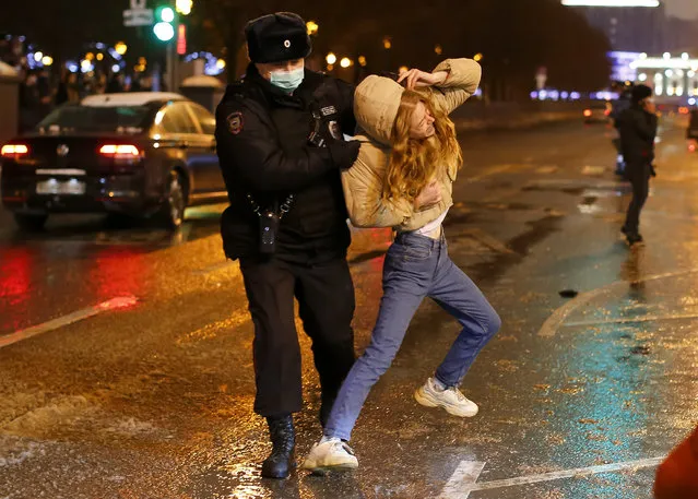 In this January 23, 2021, file photo, a police officer detains a young woman during a protest against the jailing of opposition leader Alexei Navalny in Pushkin square in Moscow, Russia. Allies of Navalny are calling for new protests next weekend to demand his release, following a wave of demonstrations across the country that brought out tens of thousands in a defiant challenge to President Vladimir Putin. (Photo by Alexander Zemlianichenko/AP Photo/File)