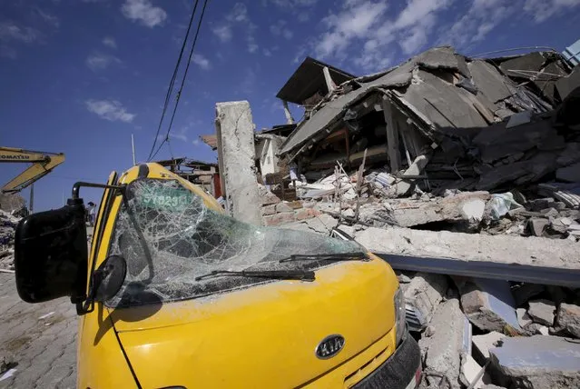 A flattened car is seen under the debris of a collapsed hotel after an earthquake struck off the Pacific coast, in Pedernales, Ecuador, April 19, 2016. (Photo by Henry Romero/Reuters)