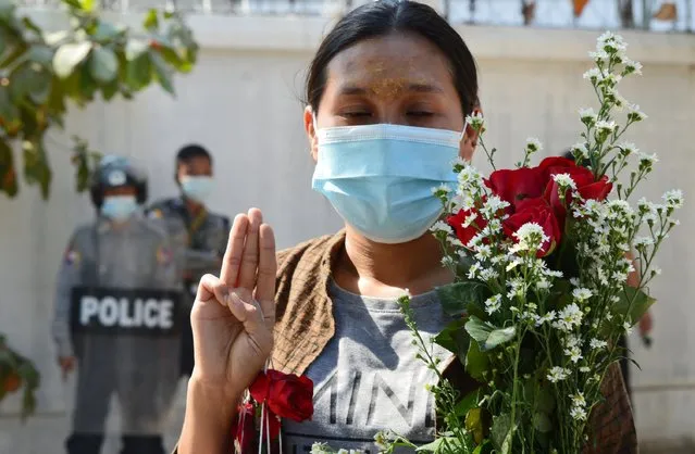 A relative of a protester who was arrested during Thursday's protest in front of Mandalay Medical University, makes a three finger salute at a court in Mandalay, Myanmar on February 5, 2021. (Photo by Reuters/Stringer)