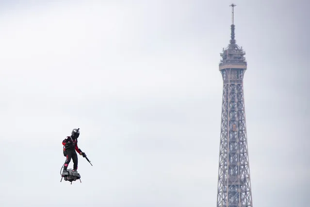 Professional pilot Franky Zapata demonstrates a flight on a “flyboard”, which the French army is considering using for military purposes, during the annual Bastille Day military parade on the Champs Elysees avenue in Paris, France, 14 July 2019. Bastille Day, the French National Day, is held annually on 14 July to commemorate the storming of the Bastille fortress in 1789. (Photo by Ian Langsdon/EPA/EFE)