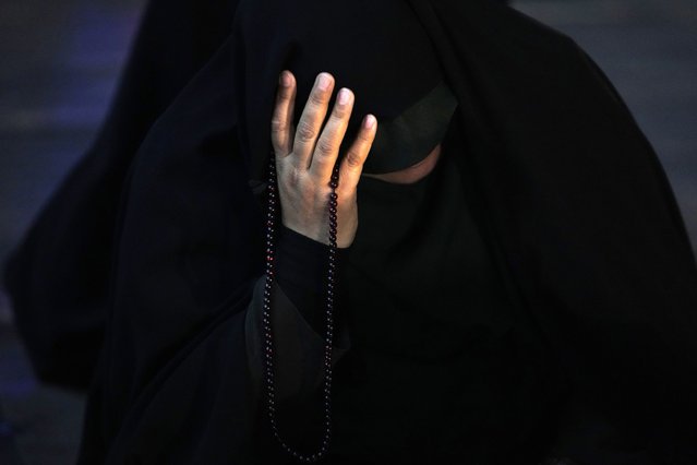 An Iranian woman prays for President Ebrahim Raisi in a ceremony at Vali-e-Asr square in downtown Tehran, Iran, Sunday, May 19, 2024. A helicopter carrying President Raisi, the country's foreign minister and other officials apparently crashed in the mountainous northwest reaches of Iran on Sunday, sparking a massive rescue operation in a fog-shrouded forest as the public was urged to pray. (Photo by Vahid Salemi/AP Photo)