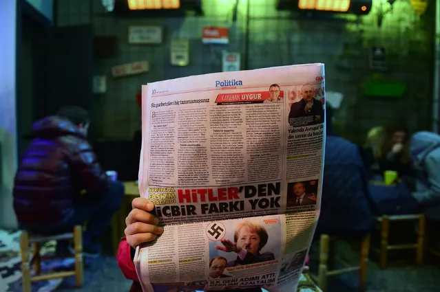 A man reads an issue of Gunes, a Turkish pro-government daily newspaper, with on an inside page German Chancellor Angela Merkel depicted in Nazi uniform with a Hitler-style moustache and doing the Nazi salute, on March 17, 2017 in Istanbul, Turkey. Right-wing tabloid-style daily Gunes (“Sun”) printed the picture along with the words in German: “#Frau Hitler” and called her an “ugly aunt”, amid a bitter war of words between Ankara and Berlin. Turkey and Europe are locked in a bitter spat after Germany and the Netherlands blocked Turkish ministers from holding rallies to campaign for a “yes” vote in next month's referendum on expanding President Recep Tayyip Erdogan's powers. (Photo by Yasin Akgul/AFP Photo)