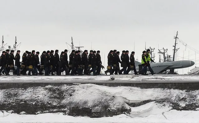 Russia's naval cadets walk along a pier at the Kronshtadt Naval base, outside Saint Petersburg, on January 19, 2022. (Photo by Olga Maltseva/AFP Photo)