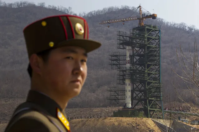 A North Korean soldier stands in front of the country's Unha-3 rocket, slated for liftoff between April 12-16, at a launching site in Tongchang-ri, North Korea on Sunday April 8, 2012. (Photo by David Guttenfelder/AP Photo)