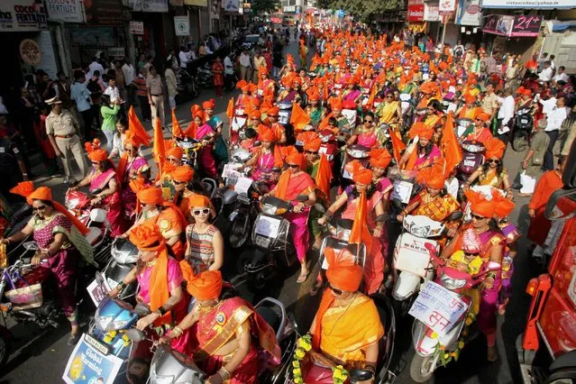 Women dressed in traditional attire ride on two wheelers as they participate in “Shobha Yatra” to celebrate the Maharashtrian new year 'Gudi Padwa' in Thane, India on Tuesday, March 28, 2017. (Photo by Press Trust of India)