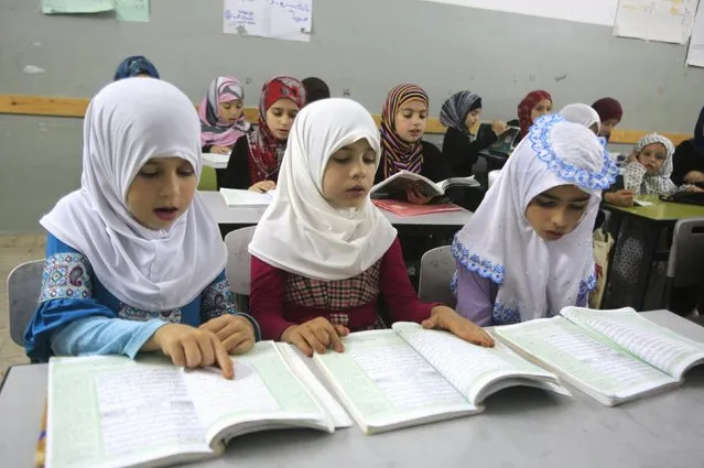 Palestinian girls read the Koran in a mosque during the holy month of Ramadan in the West Bank village of Aseera near Nablus June 30, 2015. (Photo by Abed Omar Qusini/Reuters)