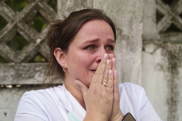 A woman reacts near the site of Okhmatdyt children’s hospital hit by Russian missiles, in Kyiv, Ukraine, Monday, July 8, 2024. Russian missiles have killed at least seven people and struck a children’s hospital in the Ukrainian capital, Kyiv, authorities say. (Photo by Evgeniy Maloletka/AP Photo)