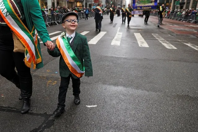 Finnian Tully, 5, New Jersey with his mom Mairead Tully, take part in the Saint Patrick's Day Parade on 5th Avenue, in the Manhattan borough of New York City, New York, U.S., March 17, 2022. (Photo by Andrew Kelly/Reuters)