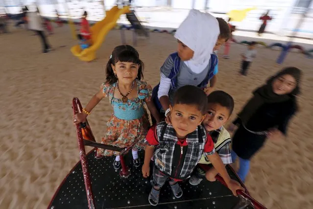Syrian refugee children play during the first day of Eid al-Fitr, marking the end of the holy month of Ramadan, at the Al-Zaatari refugee camp in Mafraq, Jordan, near the border with Syria, July 17, 2015. (Photo by Muhammad Hamed/Reuters)
