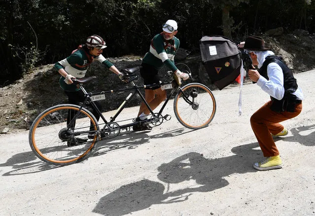 Vintage bicycle' s enthusiasts ride on a tandem on the white roads of Tuscany during the “Eroica Montalcino” festive event on May 7, 2017 near Montalcino. L' Eroica Montalcino is a cycling leisure ride along white roads that follows part of the 209 km L' Eroica route, south of Siena, in a vintage atmosphere with old bikes, Tuscany' s food and wine. (Photo by Vincenzo Pinto/AFP Photo)