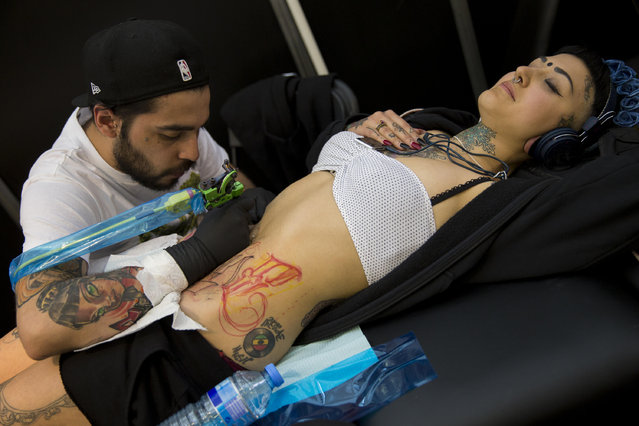 A woman gets tattooed at The Great British Tattoo Show at Alexandra Palace on May 24, 2014 in London, England. (Photo by Tristan Fewings/Getty Images for Alexandra Palace)