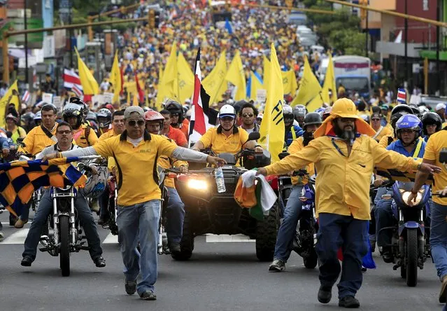 Public employees march to protest against what they say are tax injustice and the low salary increase in San Jose July 27, 2015. (Photo by Juan Carlos Ulate/Reuters)