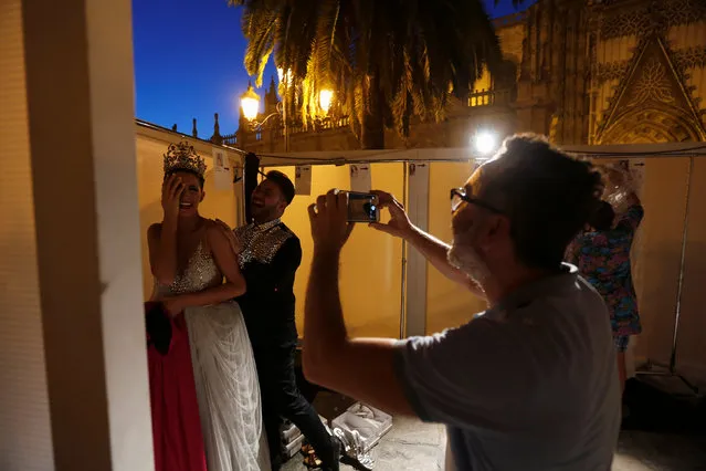 Spanish designer Pablo Lanzarote (2nd L) and a model laugh backstage during “SIQ Sevilla Handcraft and Fashion” in the Andalusian capital of Seville, southern Spain June 1, 2016. (Photo by Marcelo del Pozo/Reuters)