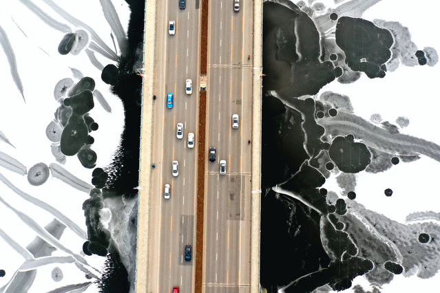 A motorway bridge crosses the icy Hunhe River in Shenyang, China on December 12, 2019. (Photo by Costfoto/Barcroft Media)