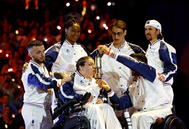 Athletes Charles Noakes, Gloria Agblemagnon, Aurelie Aubert, Ugo Didier, and Mathieu Bosredon and Frederic Villeroux of Team France extinguish the Olympic flame during the Paris 2024 Paralympic Games Closing Ceremony on day eleven of the Paris 2024 Summer Paralympic Games on September 8, 2024 in Paris, France. (Photo by Stephanie Lecocq/Reuters)