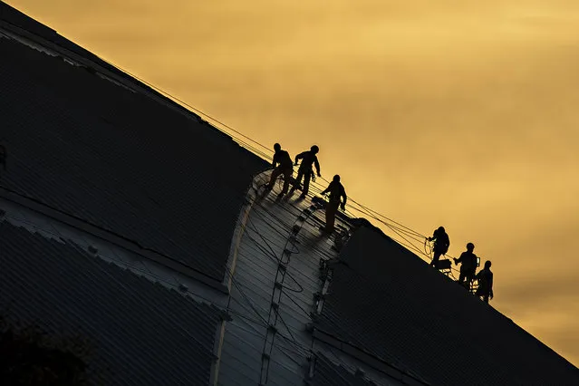 “Working on the Roof”. A group of workers seen on the roof of the new National Stadium of Singapore. Photo location: Singapore. (Photo and caption by Tong Leng Liew/National Geographic Photo Contest)
