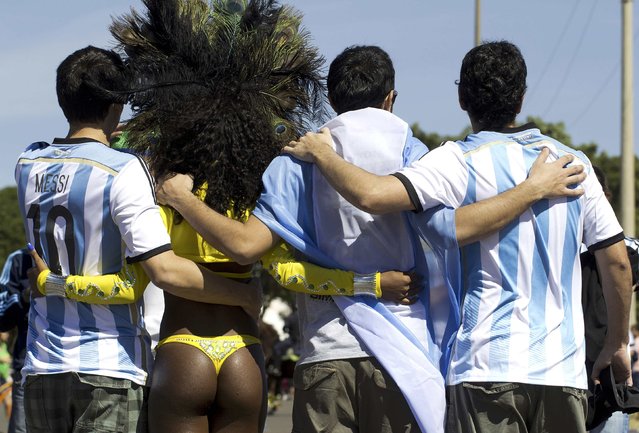 Argentina fans pose with a samba dancer outside the National Stadium where they will watch their country play Belgium for the 2014 World Cup quarter-finals in Brasilia, July 5, 2014. (Photo by Joedson Alves/Reuters)