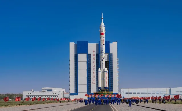 The combination of the Shenzhou-14 crewed spaceship and a Long March-2F carrier rocket is seen being transferred to the launching area of Jiuquan Satellite Launch Center on May 29, 2022 in Jiuquan, Gansu Province of China. (Photo by VCG/VCG via Getty Images)