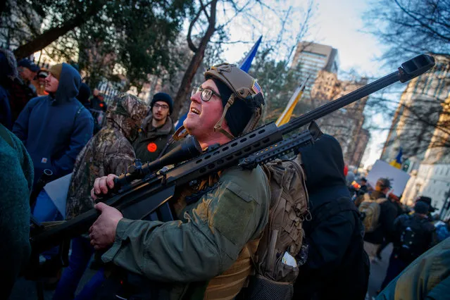 Gun-rights supporters gather for a rally outside the Virginia state capitol in Richmond, Virginia, USA, 20 January 2020. Virginia Citizens Defense League organized the rally to lobby against gun measures, introduced by Virginia's Democratic-led assembly, that would require background checks and ban guns in some public parks and buildings. The rally also attracted militia members, white supremacists, and other far-right extremists. (Photo by Shawn Thew/EPA/EFE)