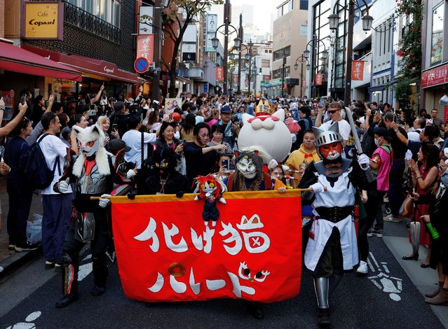 People dressed as cats and supernatural cats, known as “bakeneko”, take part in a parade to celebrate the upcoming Halloween, during the Kagurazaka Bakeneko Festival in Tokyo, Japan on October 13, 2024. (Photo by Kim Kyung-Hoon/Reuters)